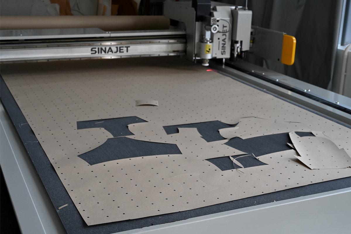 Paper pattern pieces on the cutting table.