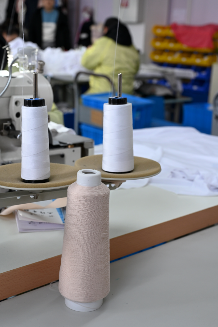 Thread spools on a worktable in the workshop.